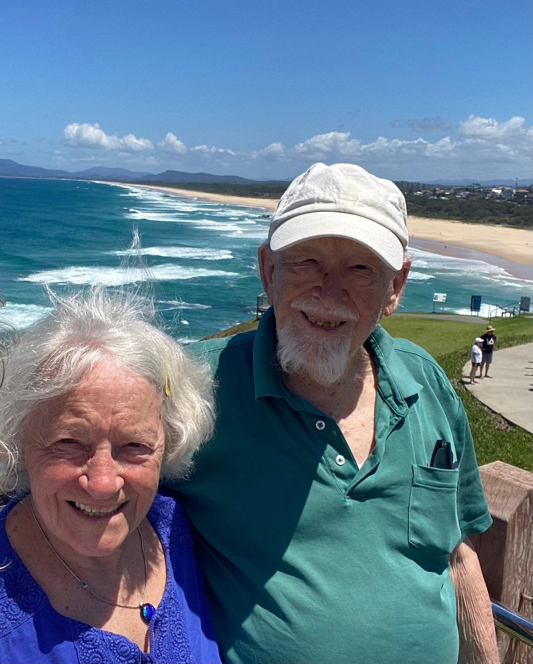 Couple smiling together by the coast
