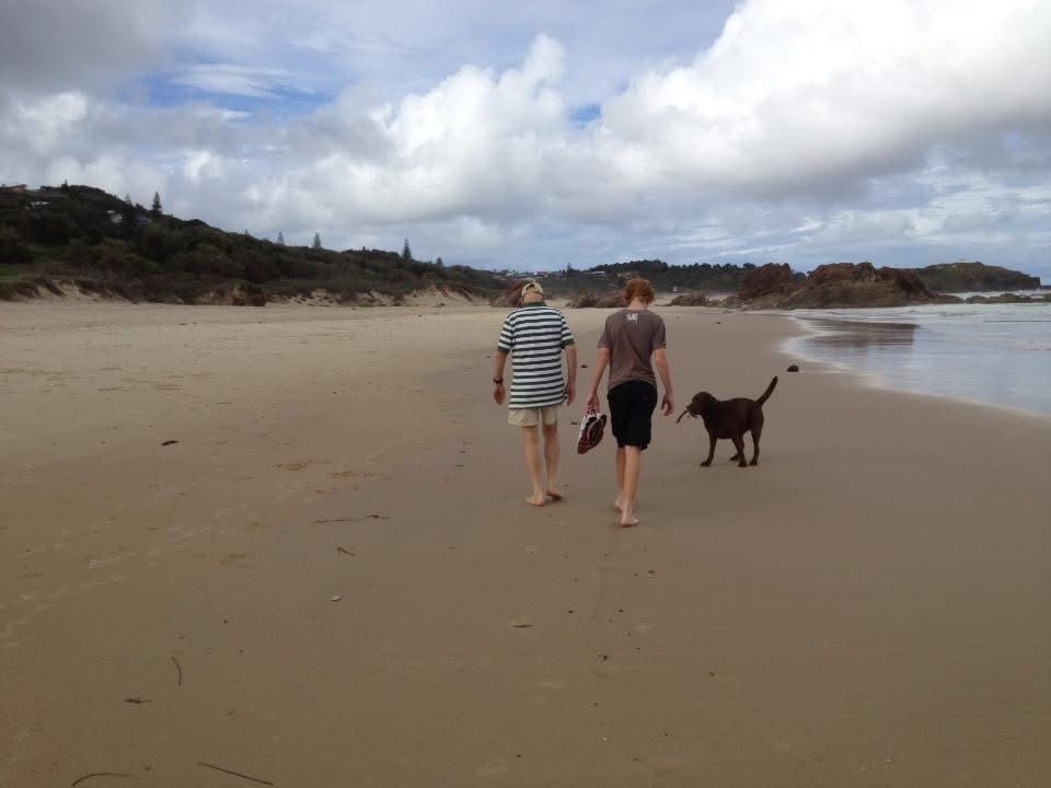 Family walking together along a sandy beach